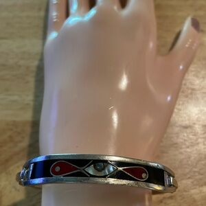 Alpaca Mexico- hinged bracelet w/black enamel background. It has red & abalone.